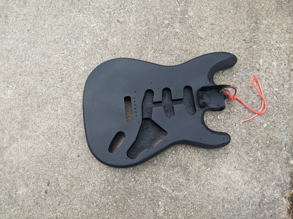 Guitar after removing finish nd painting it the mandatory Stealth Bomber black